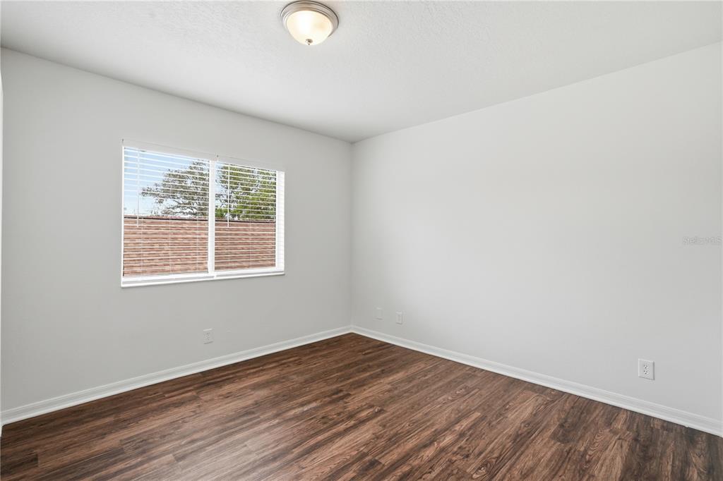 4155 Day Bridge Place Ellenton, FL 34222 - Photo 30 of 42 an empty room with wooden floor and windows