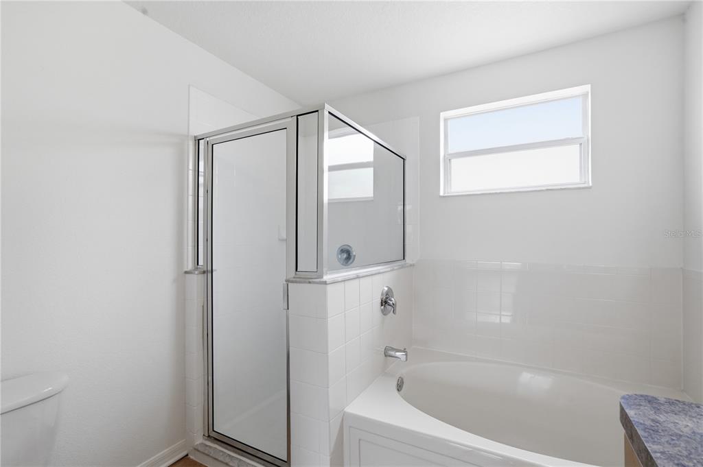 4155 Day Bridge Place Ellenton, FL 34222 - Photo 33 of 42 a bathroom with a bathtub and a shower