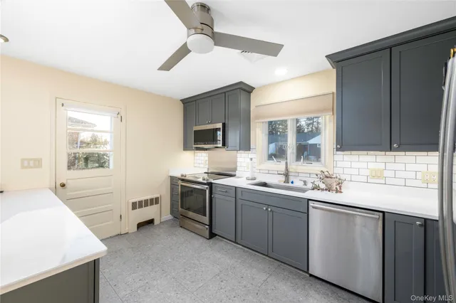 a kitchen with sink stove and cabinets
