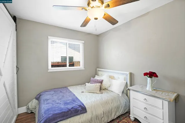 a view of a livingroom with wooden floor and a flat screen tv
