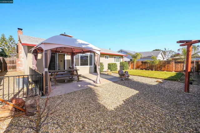 a view of a house with backyard porch and sitting area