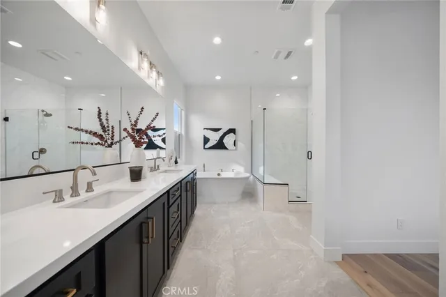 a bathroom with a double vanity sink mirror and shower