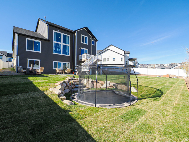 2487 Canyon Wild Road, Unit 413 Draper, UT 84020 - Photo 64 of 75 Back of property featuring a trampoline and a residential view