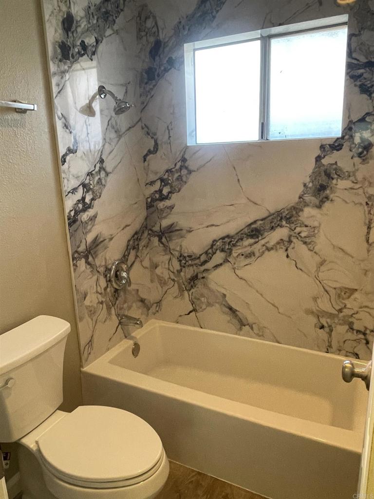9717 Winter Gardens Boulevard, Unit 194 Lakeside, CA 92040 - Photo 13 of 19 a bathroom with a toilet and a bathtub