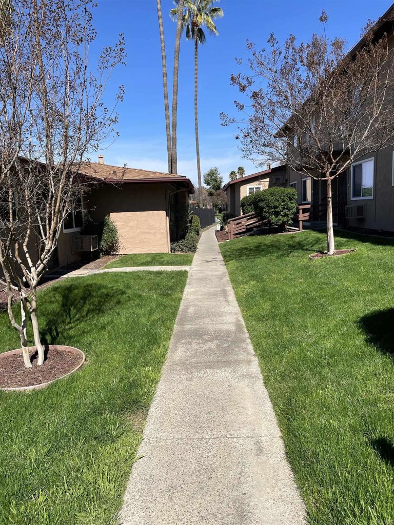 9717 Winter Gardens Boulevard, Unit 194 Lakeside, CA 92040 - Photo 4 of 19 a front view of a house with a garden and trees