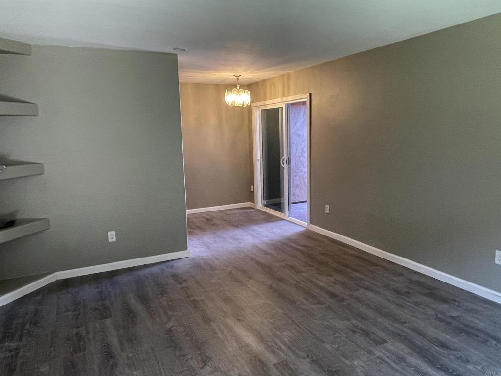 9717 Winter Gardens Boulevard, Unit 194 Lakeside, CA 92040 - Photo 5 of 19 a view of an empty room with wooden floor and a window