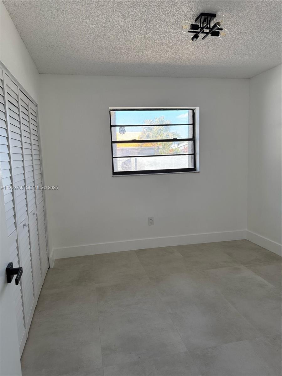 15332 Southwest 80th Lane, Unit 15332 Miami, FL 33193 - Photo 11 of 16 a view of an empty room with a window