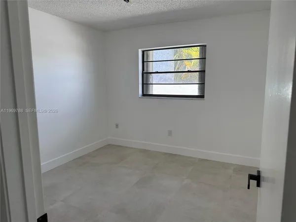 an empty room with windows and wall