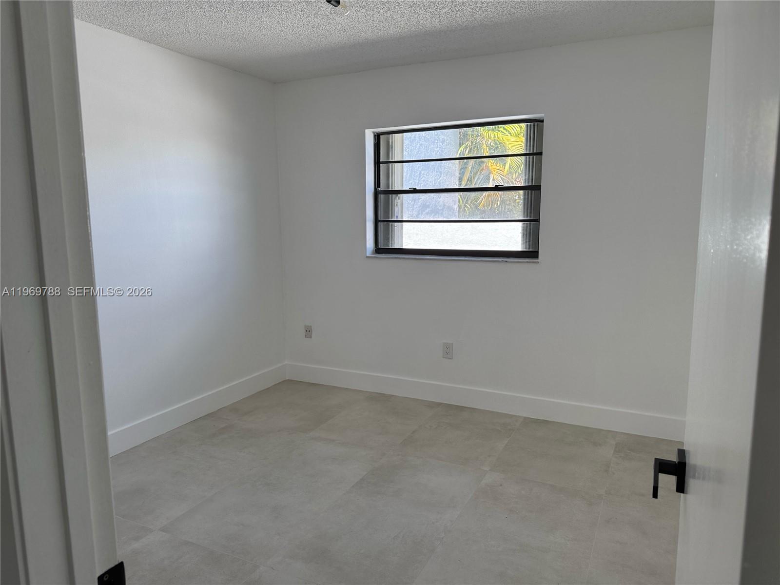 15332 Southwest 80th Lane, Unit 15332 Miami, FL 33193 - Photo 6 of 16 an empty room with windows and wall