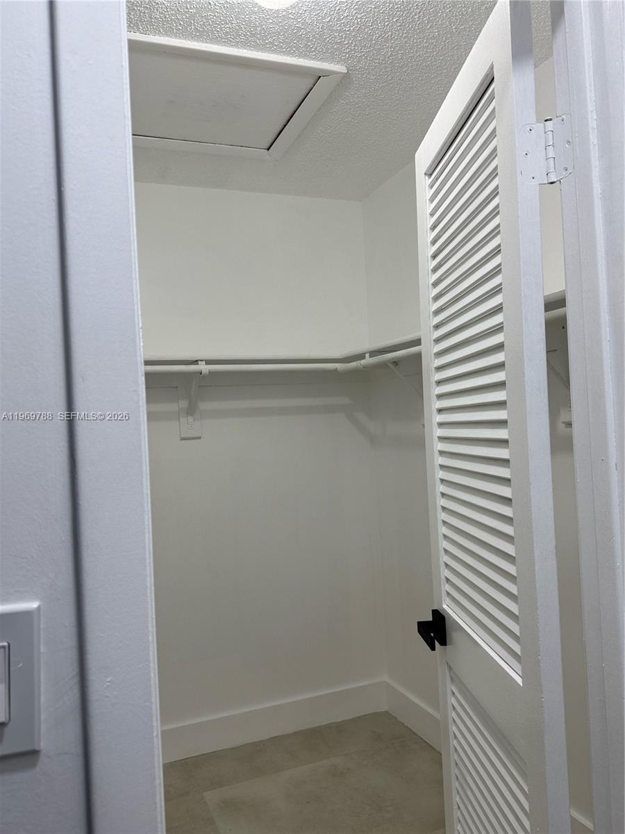 15332 Southwest 80th Lane, Unit 15332 Miami, FL 33193 - Photo 8 of 16 a view of a room with a white door