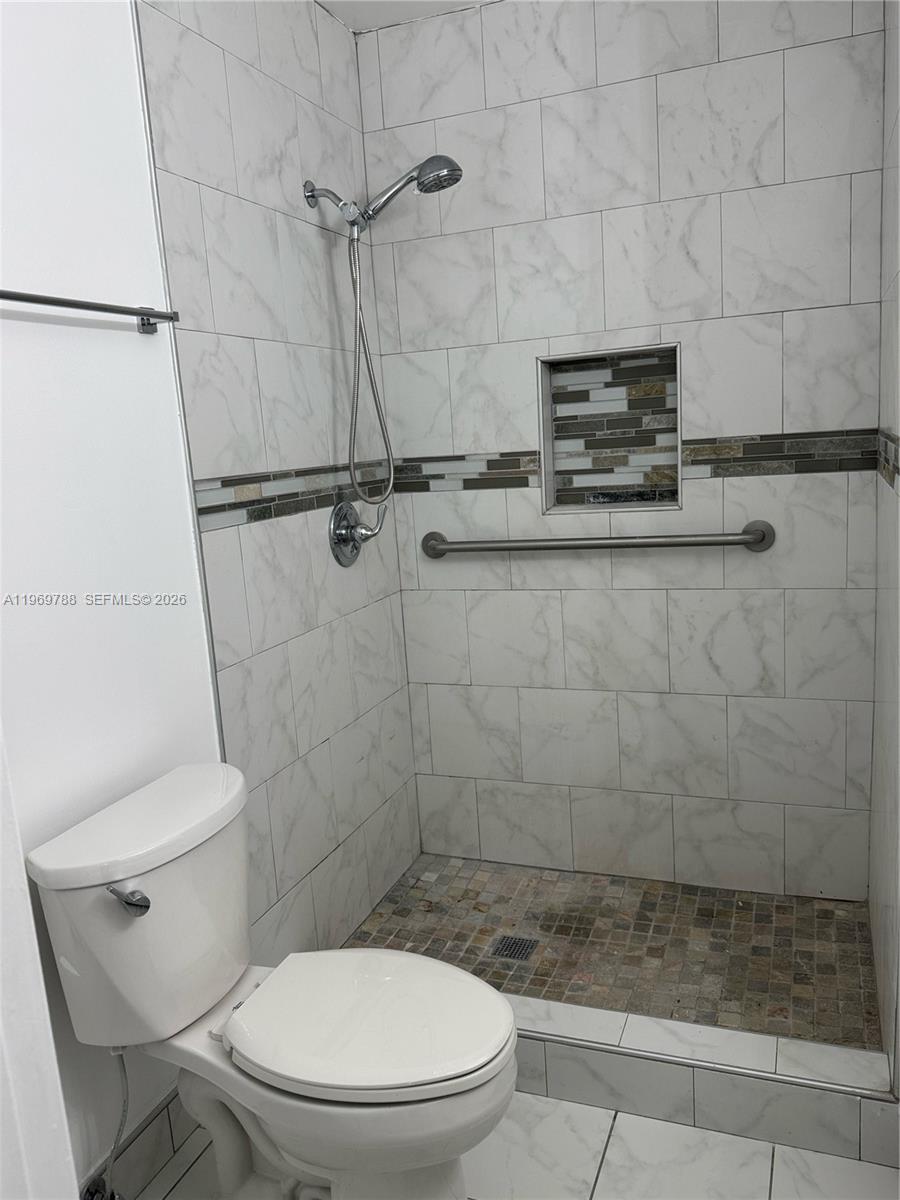 15332 Southwest 80th Lane, Unit 15332 Miami, FL 33193 - Photo 10 of 16 a bathroom with a toilet and a shower