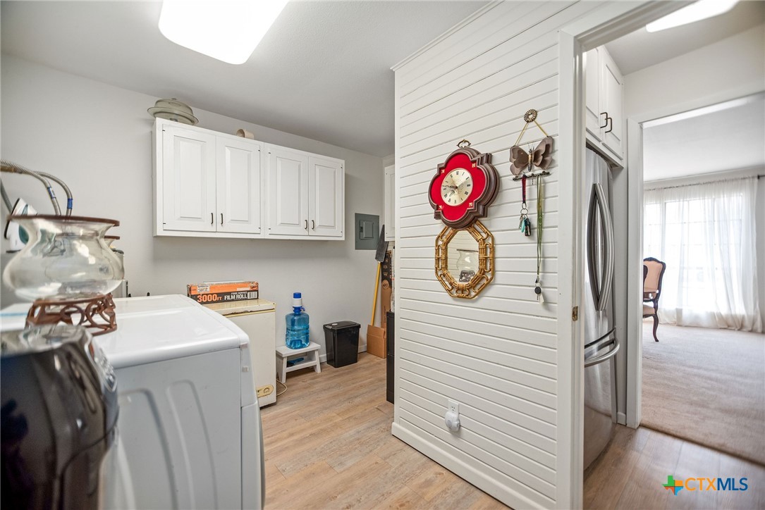 207 Williams Street Tivoli, TX 77990 - Photo 17 of 32 a utility room with fridge and wooden floor