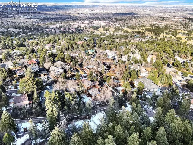 an aerial view of residential houses with city and outdoor space
