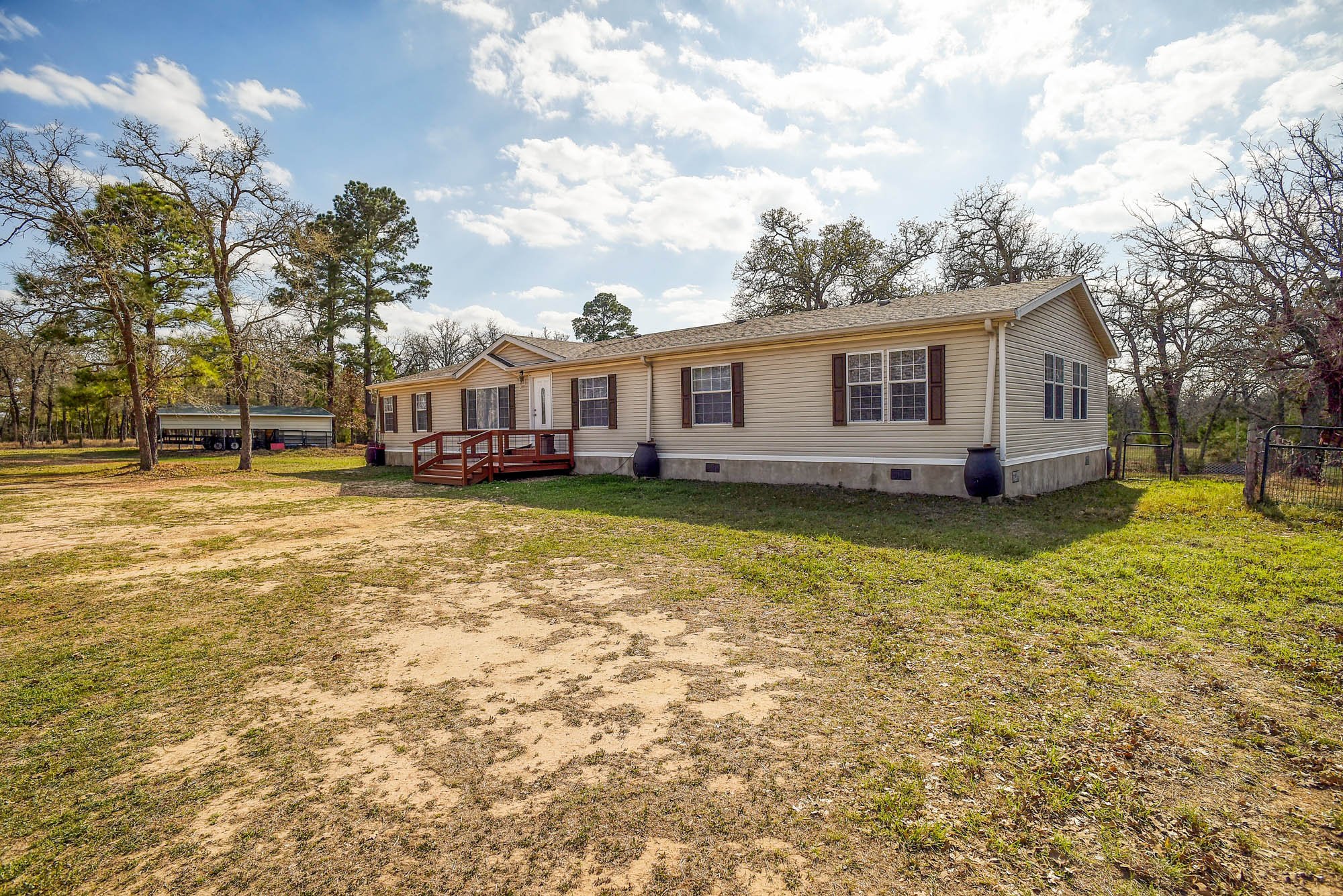 552 South Old Potato Road Paige, TX 78659 - Photo 1 of 40 a view of a house with a yard patio and a garden