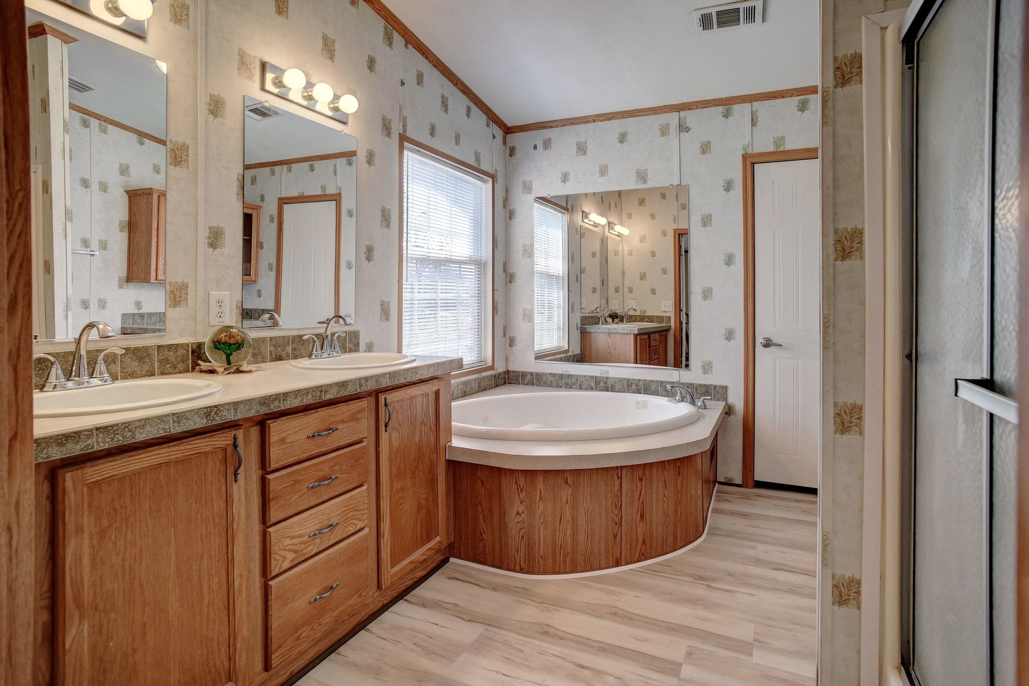 552 South Old Potato Road Paige, TX 78659 - Photo 17 of 40 a bathroom with a granite countertop sink a mirror and a shower