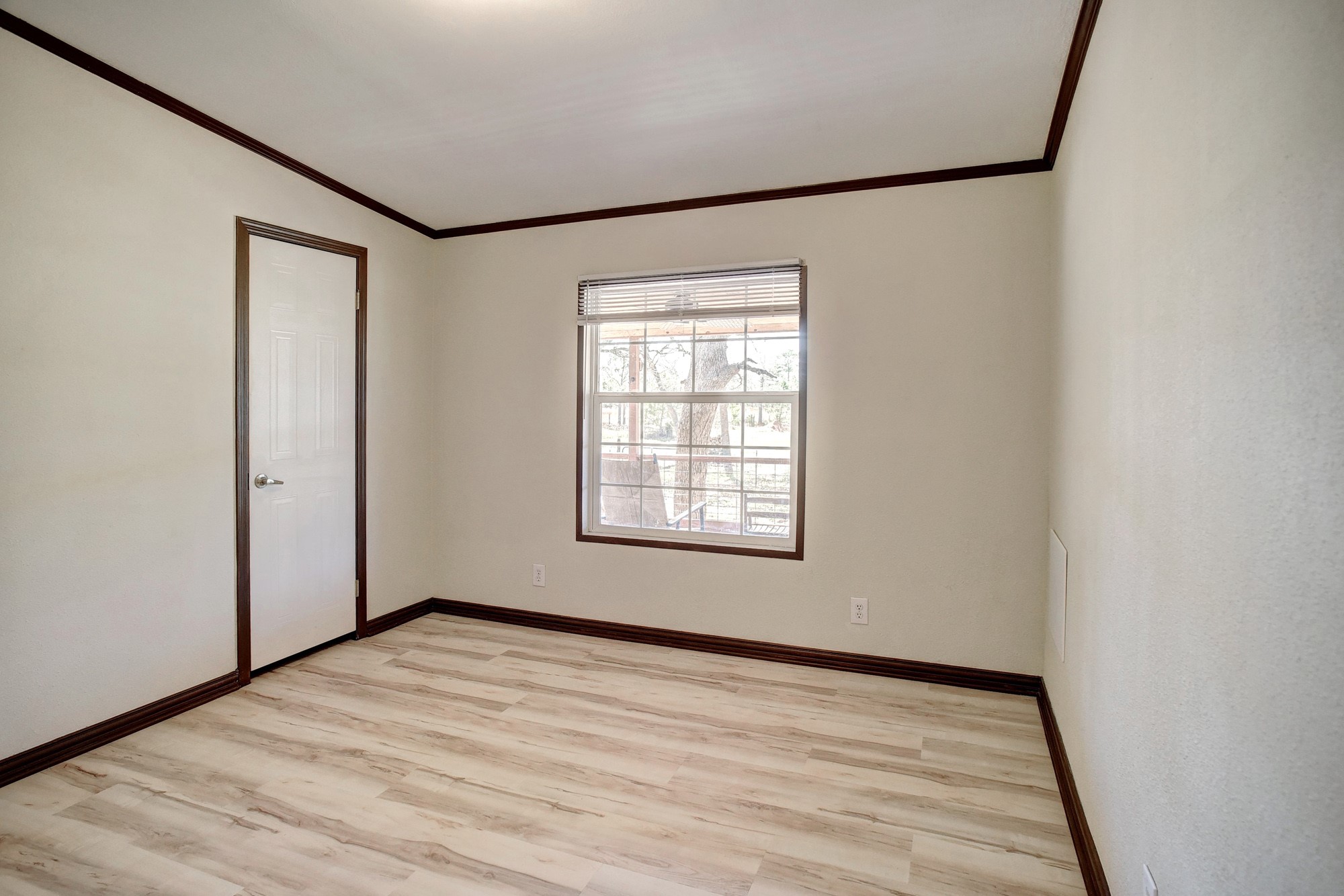 552 South Old Potato Road Paige, TX 78659 - Photo 22 of 40 a view of an empty room with wooden floor and a window
