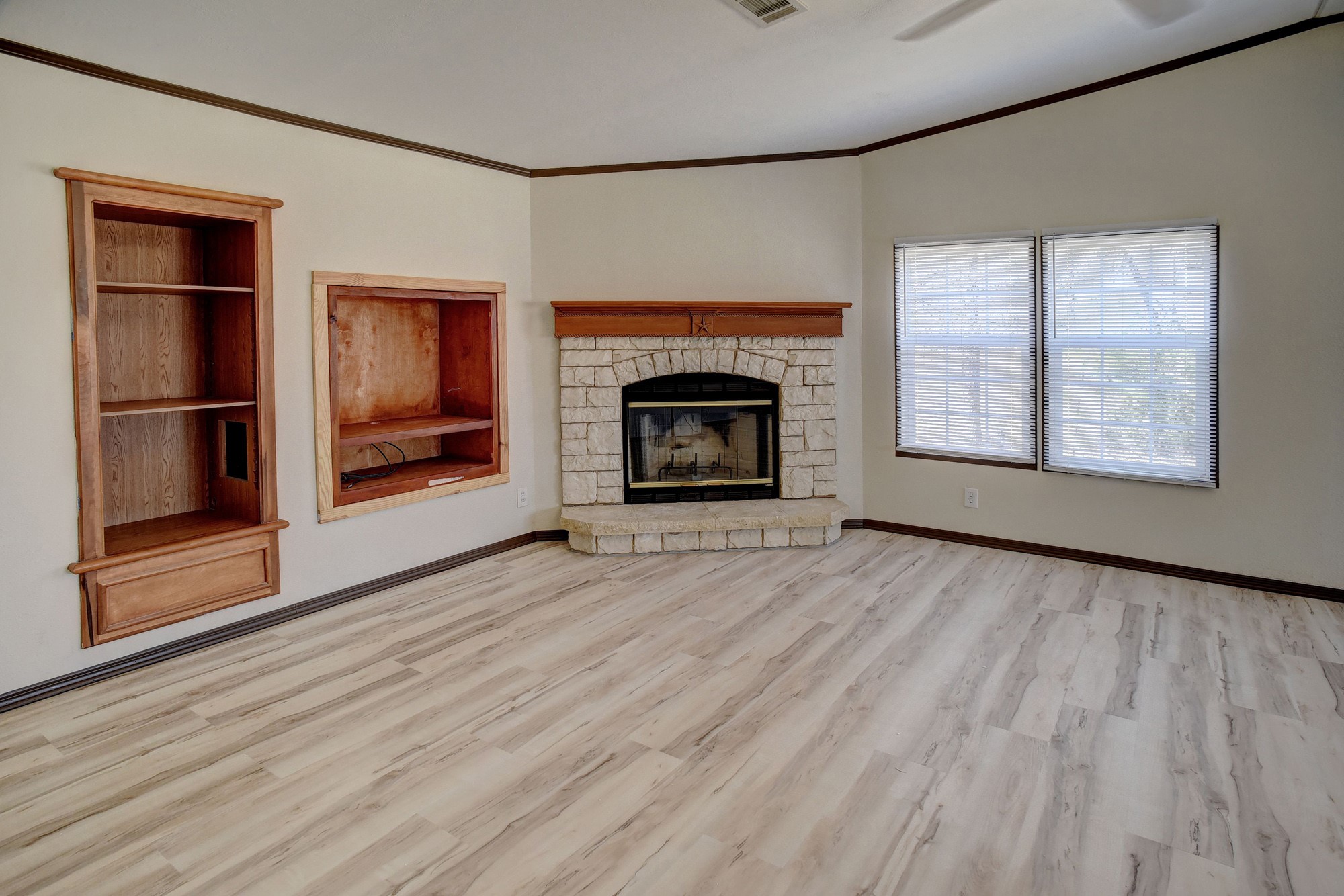 552 South Old Potato Road Paige, TX 78659 - Photo 26 of 40 an empty room with wooden floor fireplace and windows