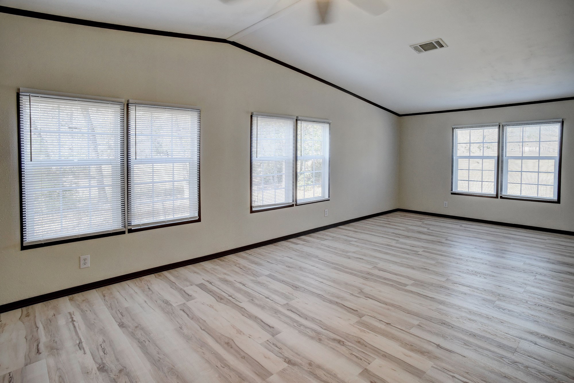 552 South Old Potato Road Paige, TX 78659 - Photo 27 of 40 an empty room with wooden floor and windows