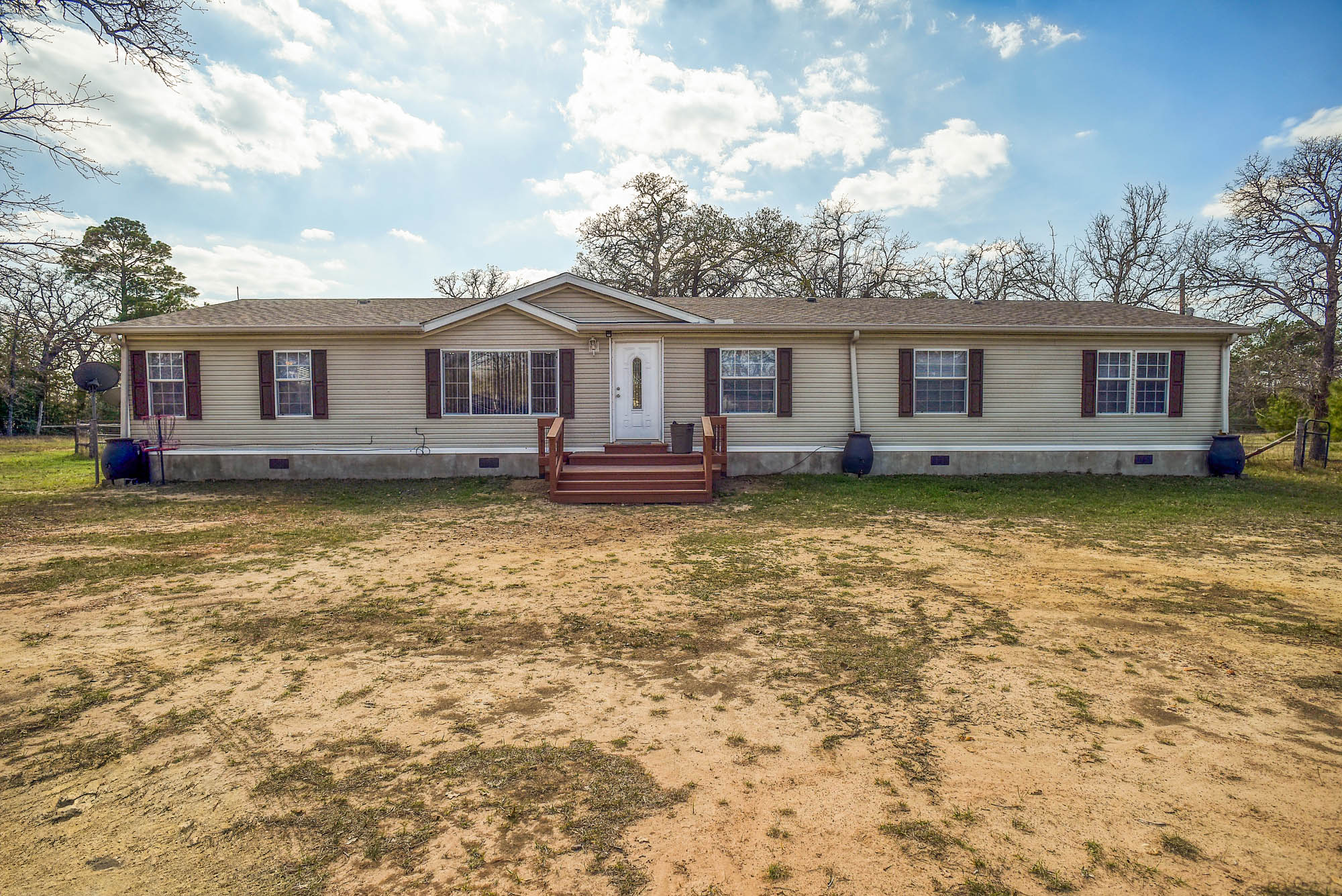 552 South Old Potato Road Paige, TX 78659 - Photo 3 of 40 a view of a house with a big yard and large tree