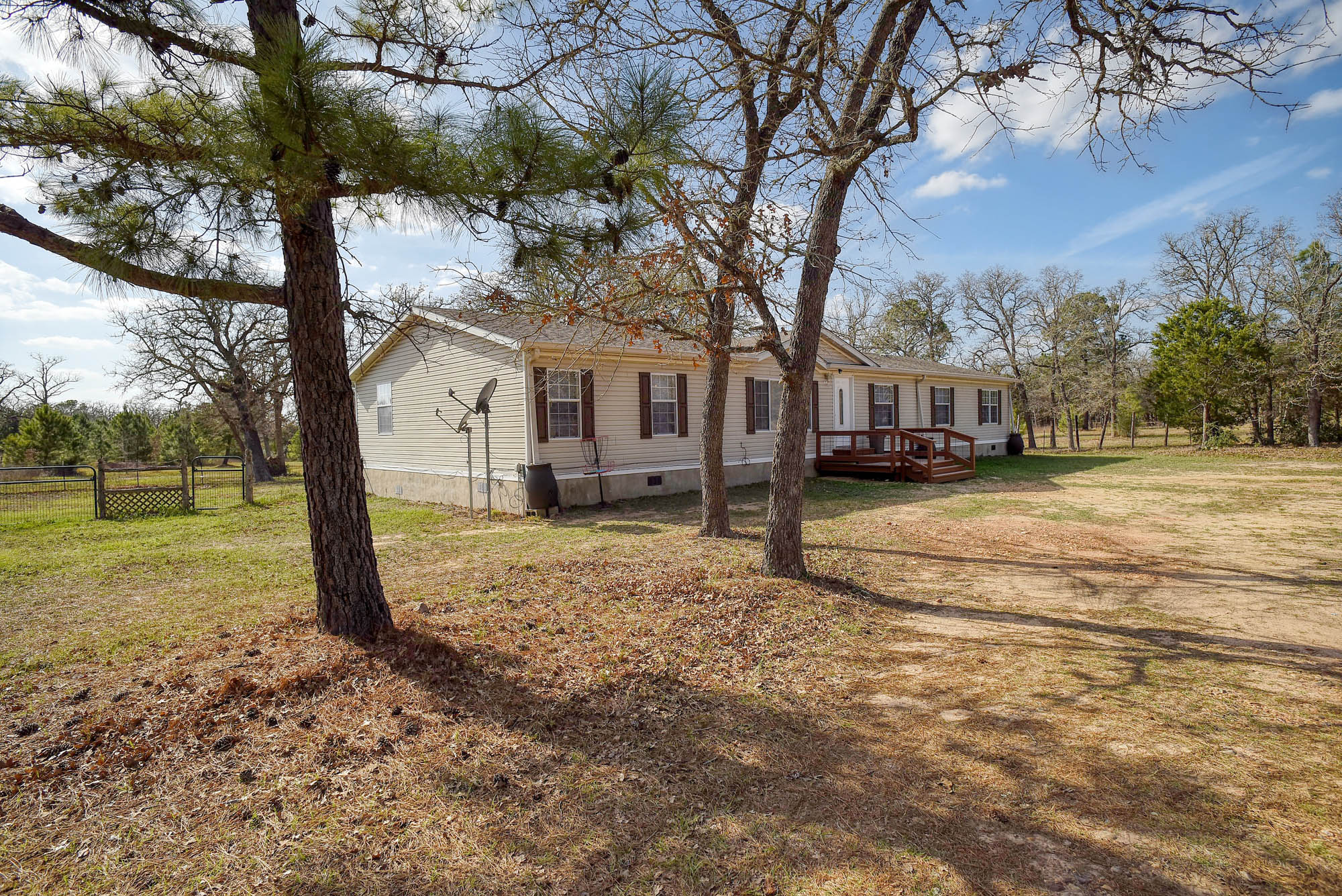 552 South Old Potato Road Paige, TX 78659 - Photo 3 of 40 a view of a yard with plants and trees