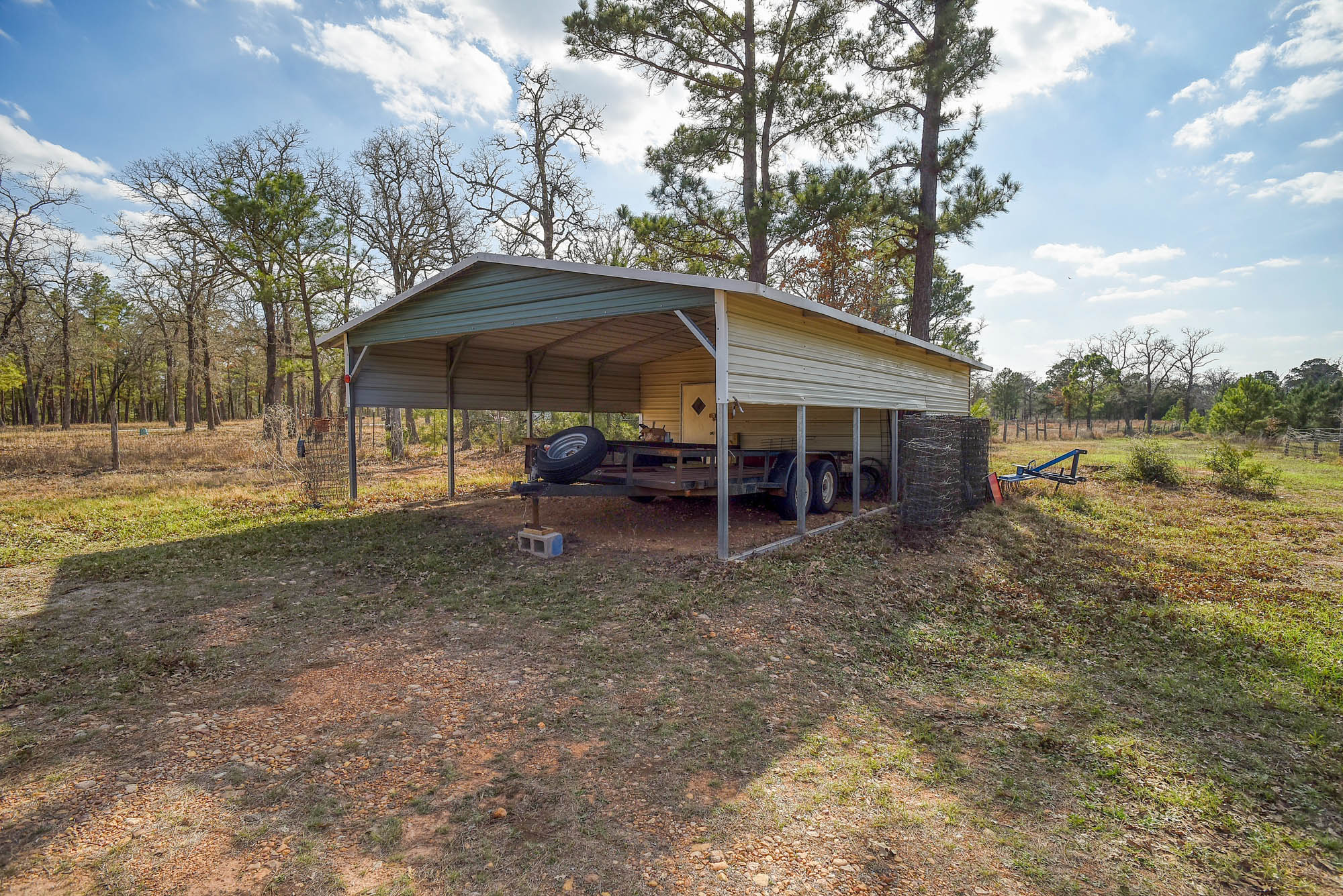 552 South Old Potato Road Paige, TX 78659 - Photo 30 of 40 The carport with a storage room in the back offers protection on many levels.