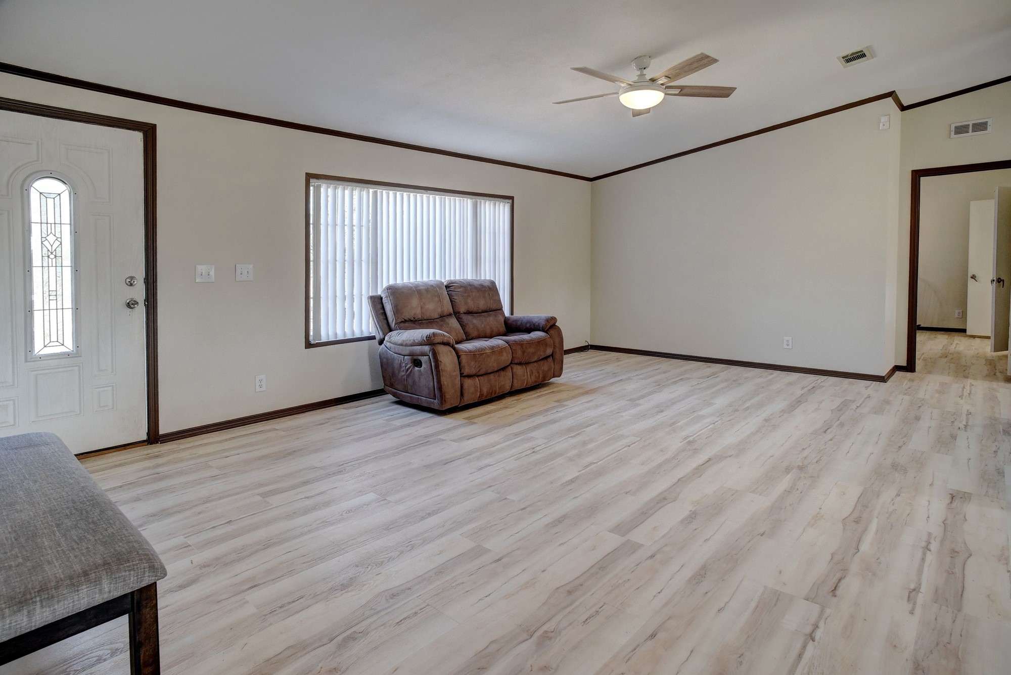 552 South Old Potato Road Paige, TX 78659 - Photo 7 of 40 a view of a livingroom with furniture cabinet wooden floor and a ceiling fan