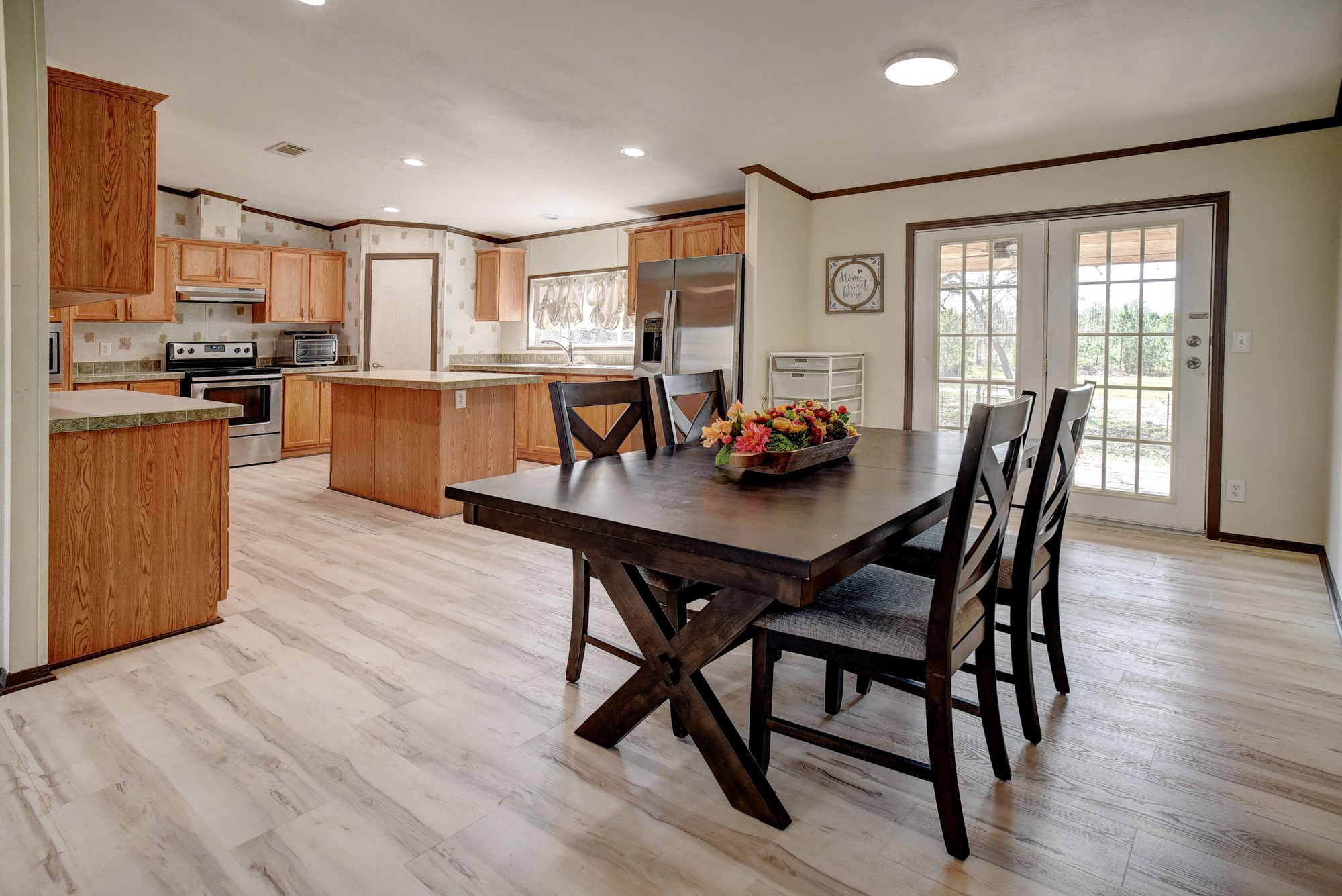 552 South Old Potato Road Paige, TX 78659 - Photo 9 of 40 a view of a dining room with furniture and wooden floor
