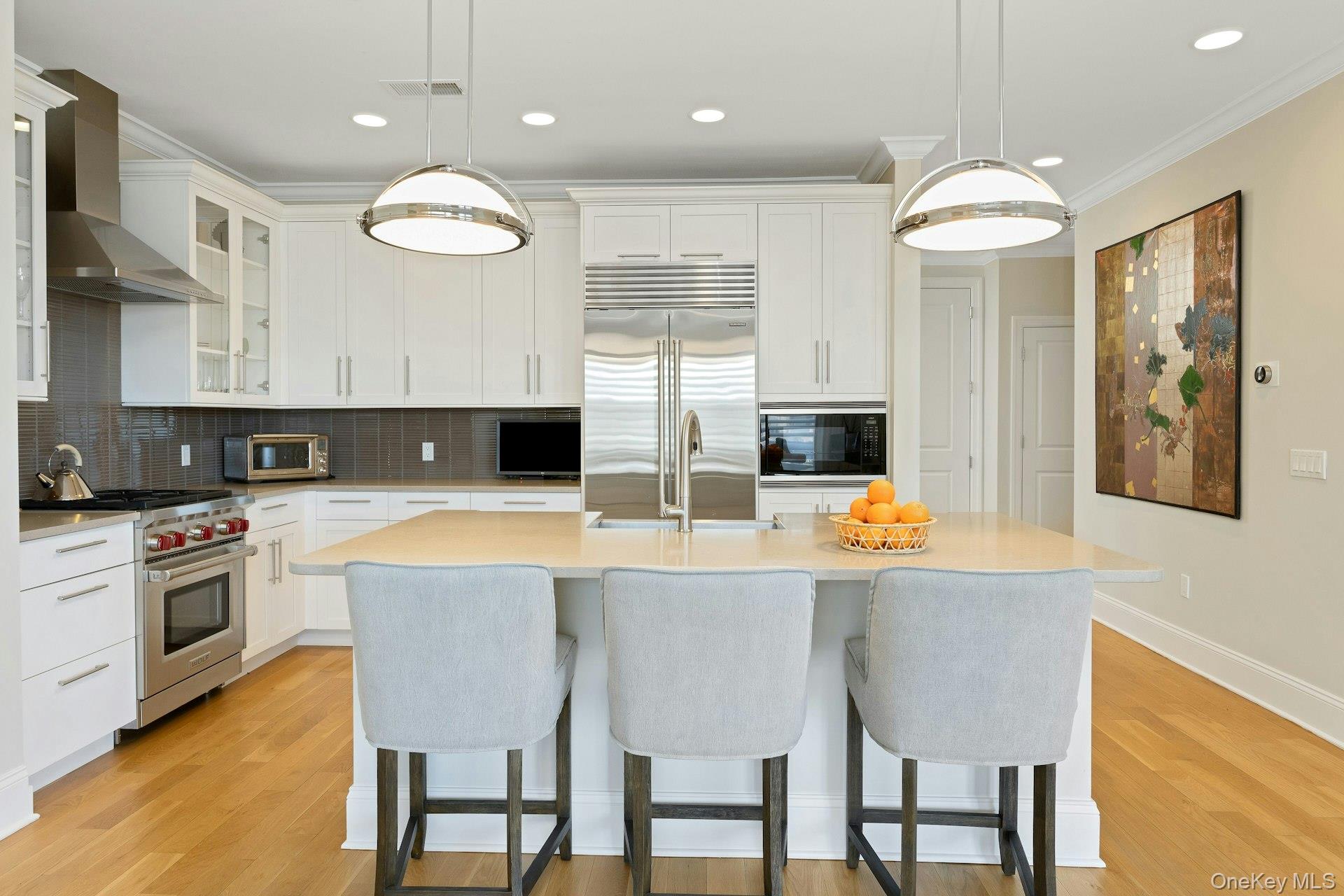 18 Rivers Edge Drive, Unit 305 Tarrytown, NY 10591 - Photo 14 of 34 a kitchen with stainless steel appliances granite countertop a stove top oven a refrigerator a sink and a dining table with chairs