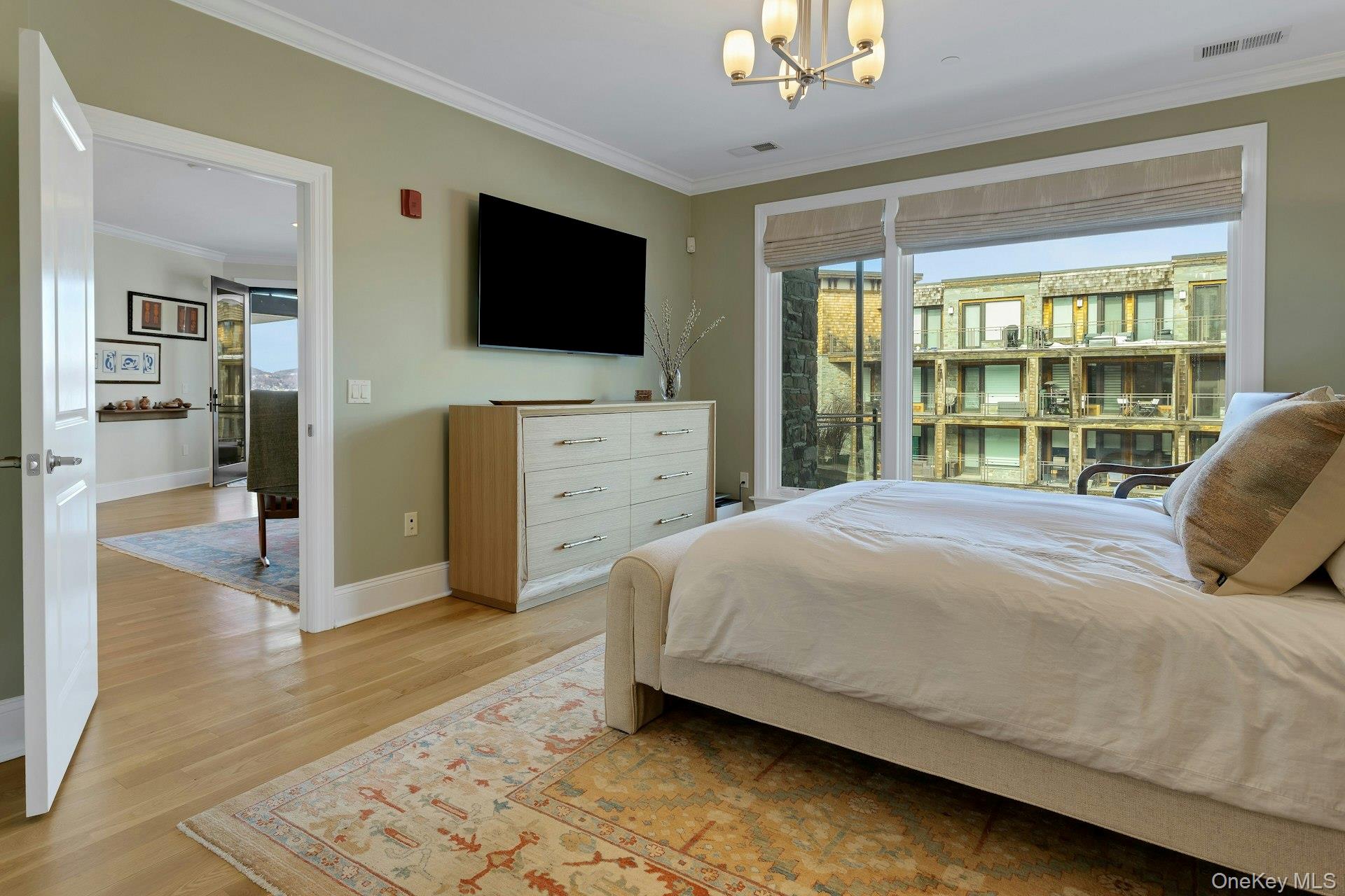 18 Rivers Edge Drive, Unit 305 Tarrytown, NY 10591 - Photo 16 of 34 a bedroom with a bed and a flat screen tv