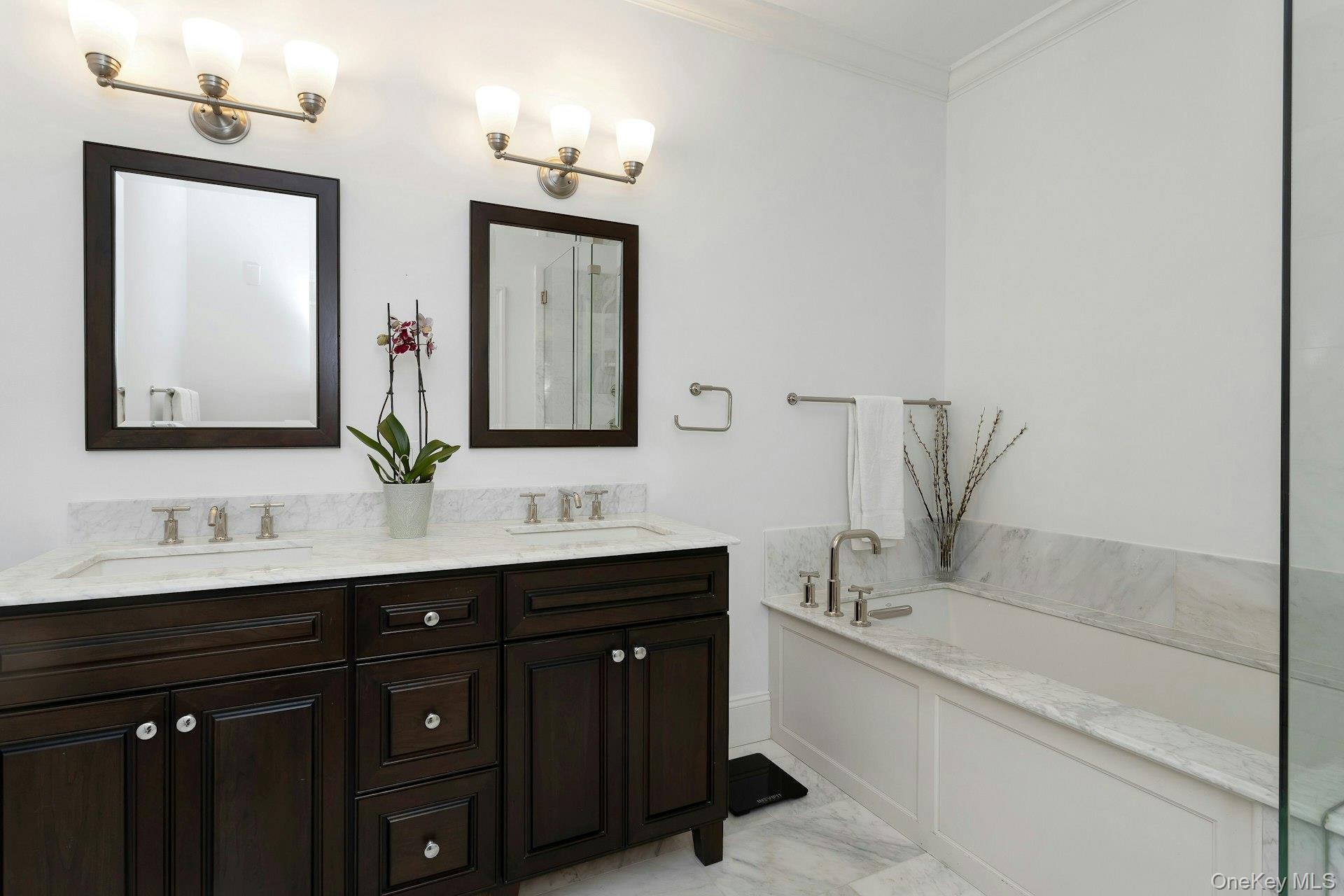 18 Rivers Edge Drive, Unit 305 Tarrytown, NY 10591 - Photo 17 of 34 a bathroom with a double vanity sink a bathtub and a mirror