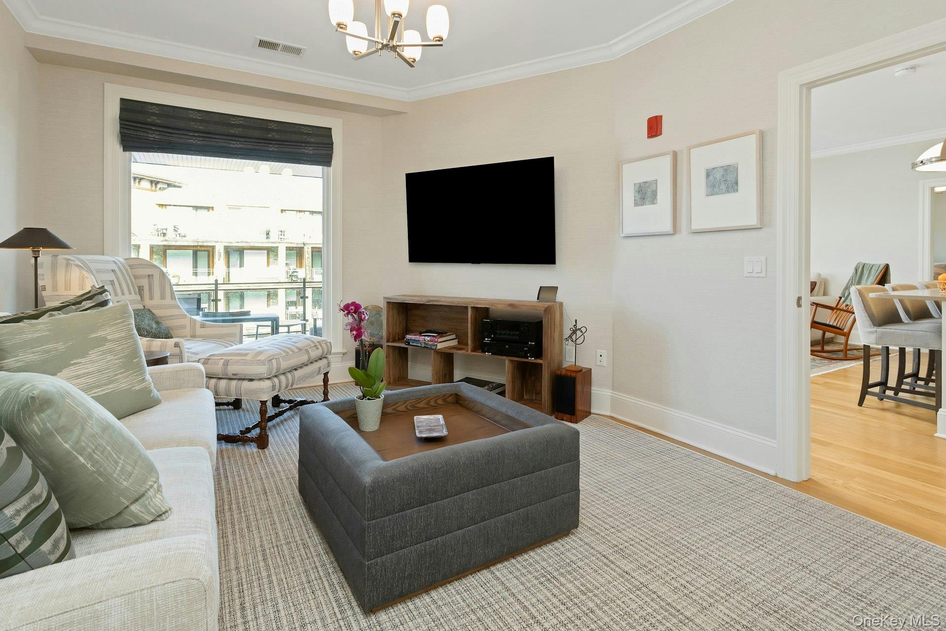 18 Rivers Edge Drive, Unit 305 Tarrytown, NY 10591 - Photo 20 of 34 a living room with furniture and a flat screen tv