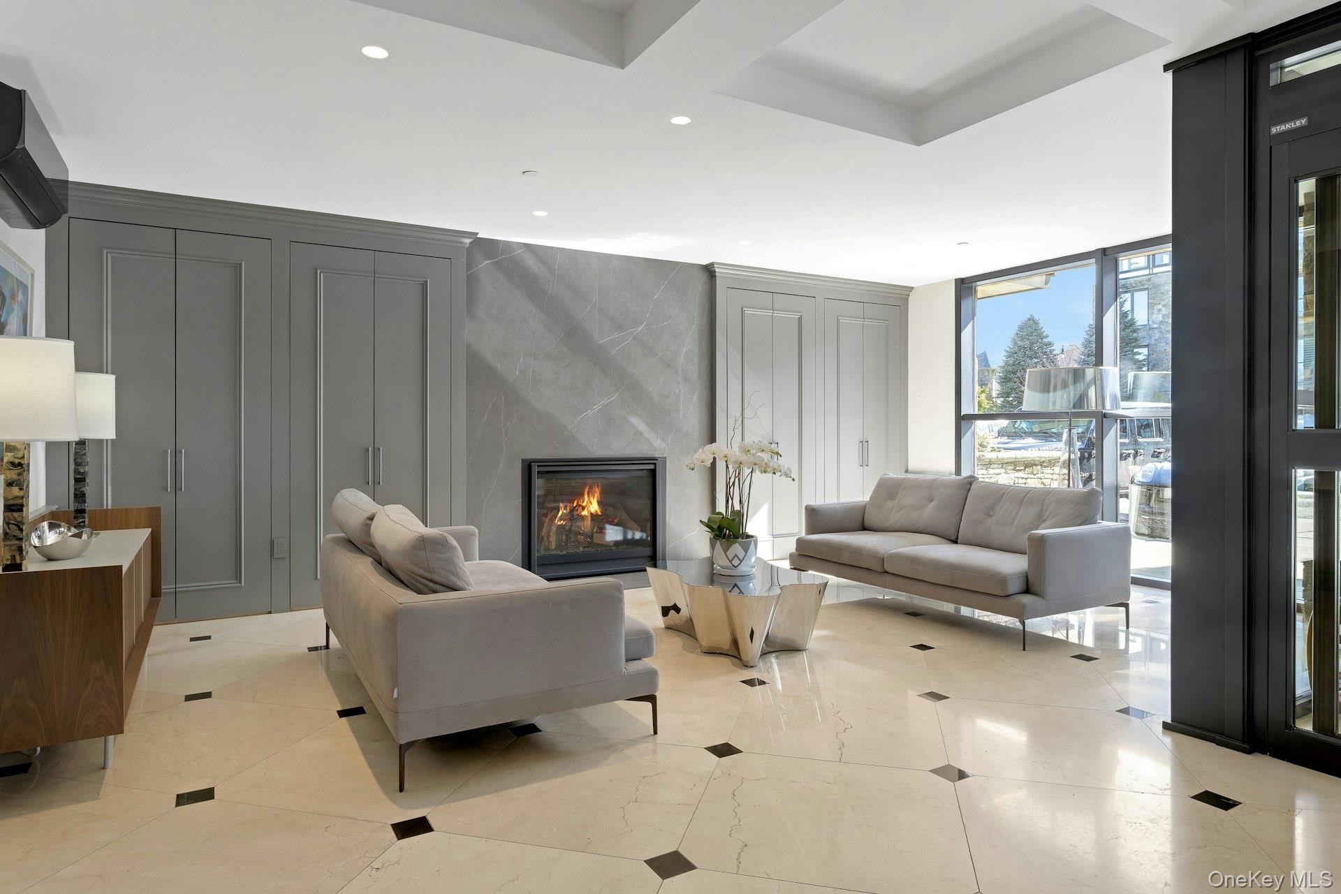 18 Rivers Edge Drive, Unit 305 Tarrytown, NY 10591 - Photo 24 of 34 a living room with furniture and a fireplace