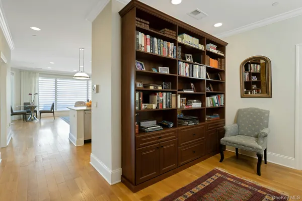 a living room with furniture and a book shelf