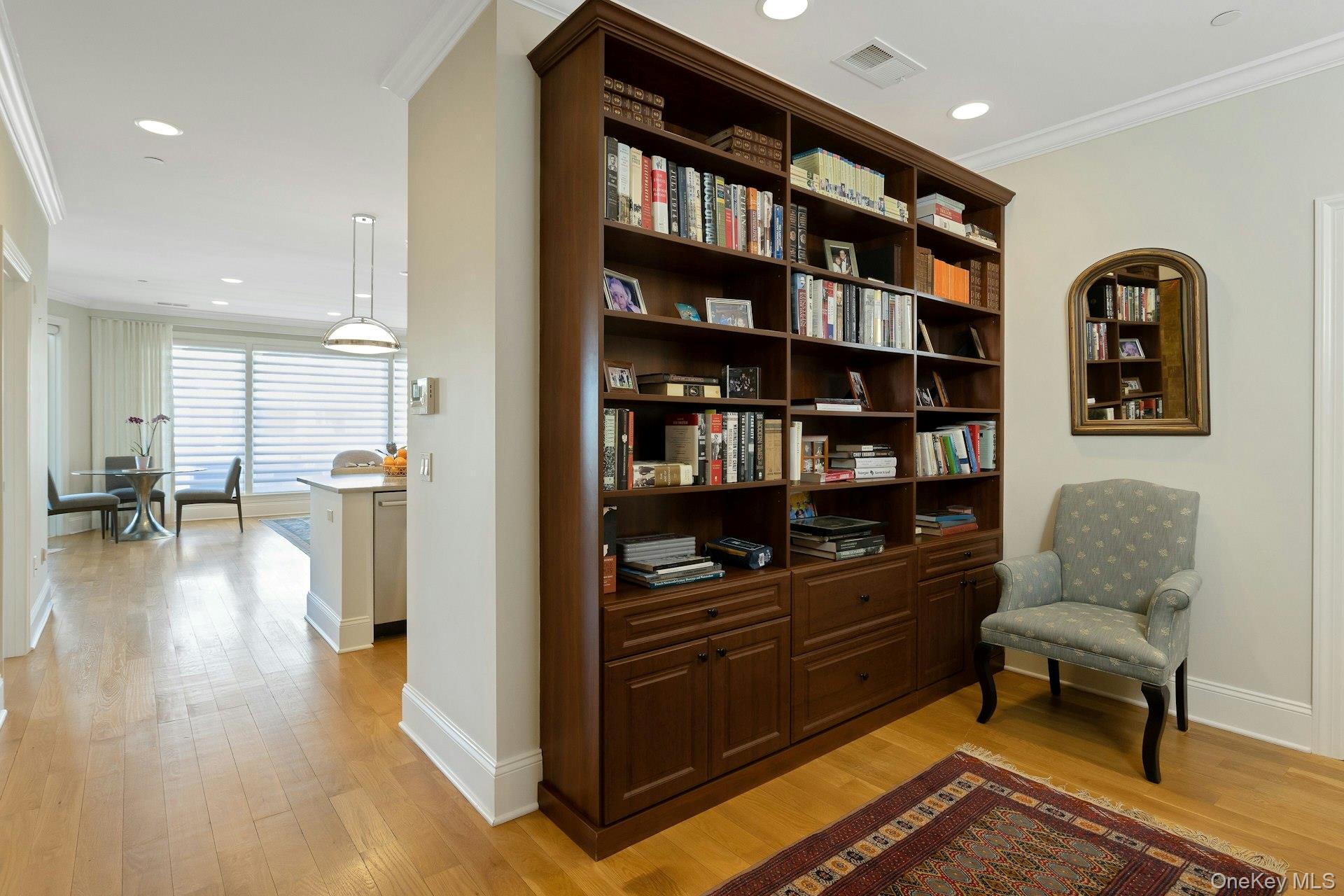 18 Rivers Edge Drive, Unit 305 Tarrytown, NY 10591 - Photo 4 of 34 a living room with furniture and a book shelf