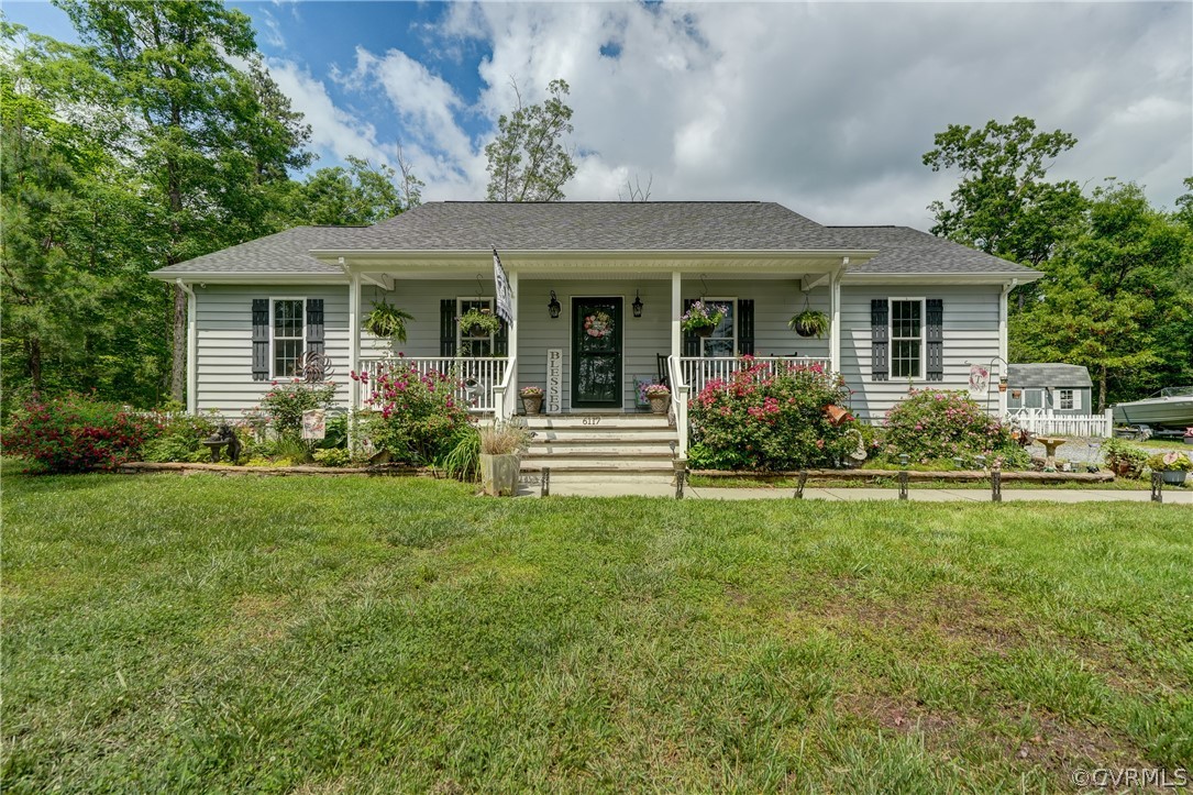 6117 West River Road Aylett, VA 23009 - Photo 1 of 30 a front view of a house with garden