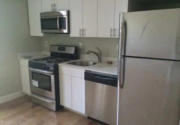 a kitchen with a refrigerator sink and microwave