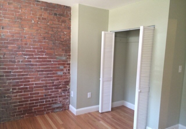 35 Forbes Street, Unit 1 Boston, MA 02130 - Photo 2 of 6 a view of an empty room with wooden floor and a window