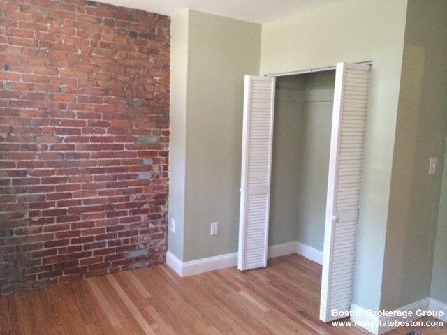 35 Forbes Street, Unit 1 Boston, MA 02130 - Photo 2 of 6 a view of an empty room with wooden floor and a window