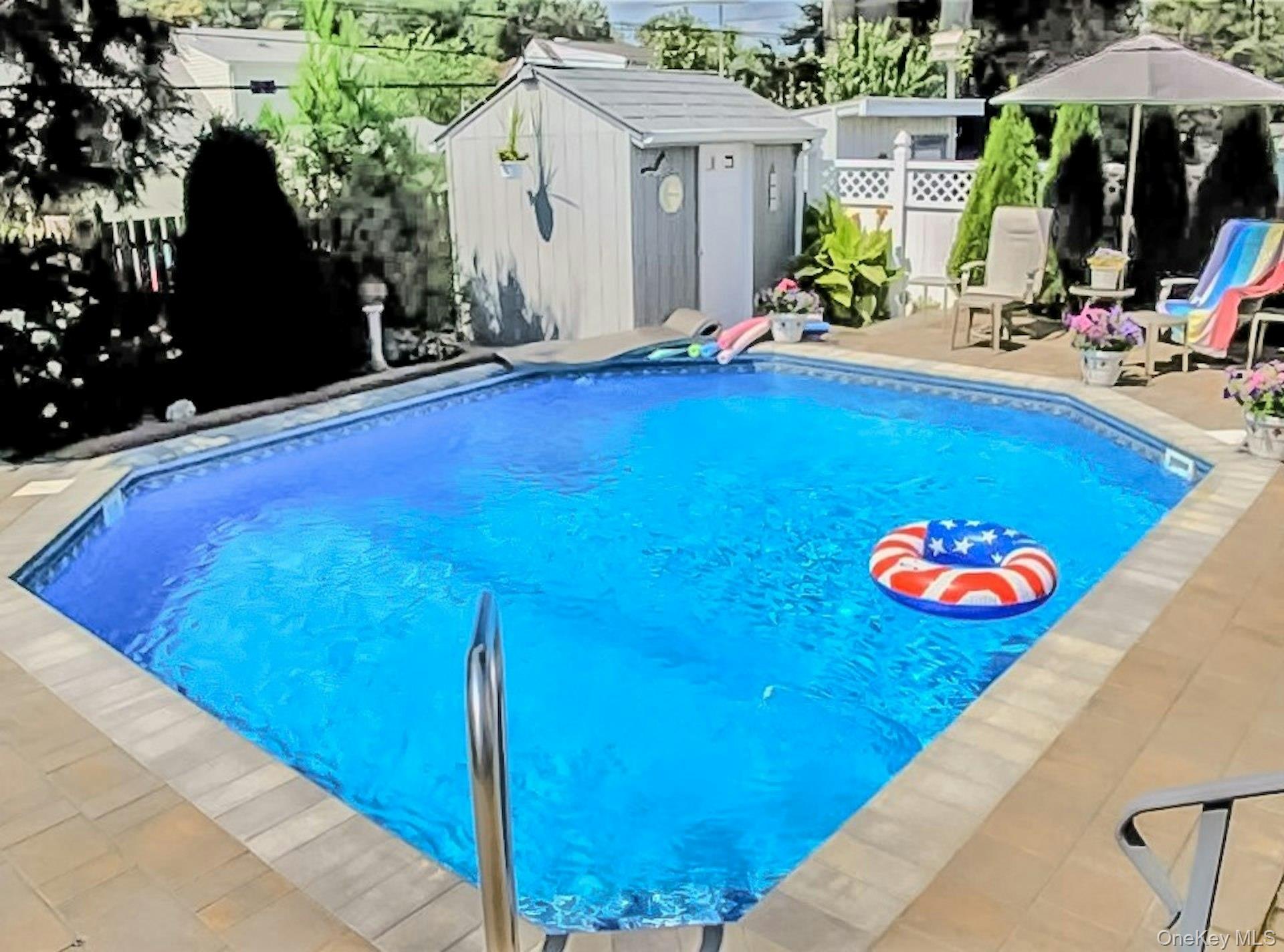 5 Sherwood Road Glen Cove, NY 11542 - Photo 25 of 26 View of pool featuring a storage shed, a fenced backyard, and patio surround