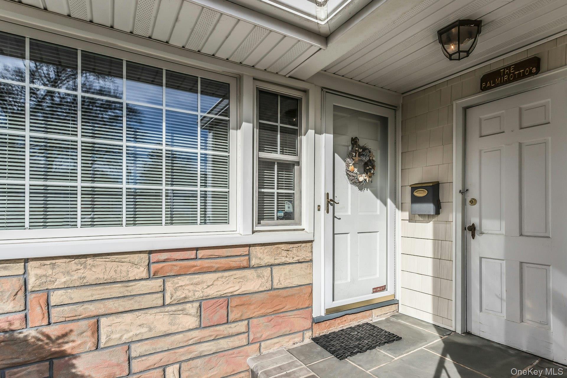 5 Sherwood Road Glen Cove, NY 11542 - Photo 4 of 26 bluestone entry with front door and garage side door