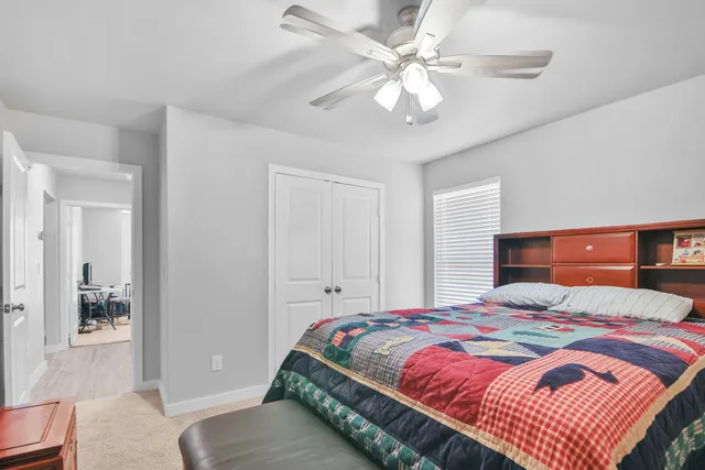 a bedroom with a large bed and a chandelier
