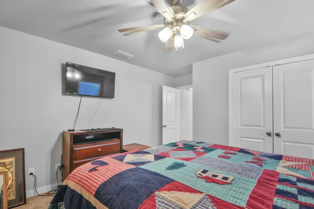 a bedroom with a bed and a chandelier