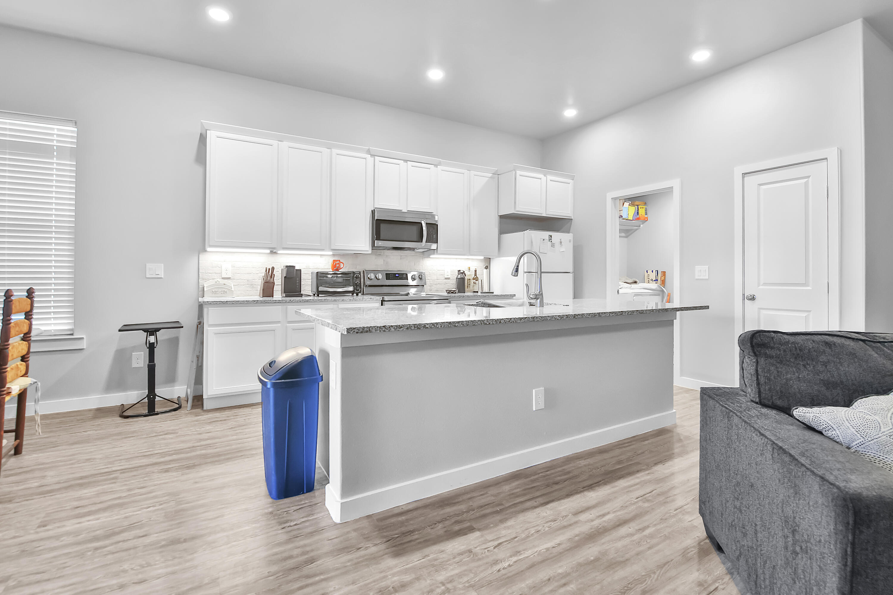 1716 133rd Street Lubbock, TX 79423 - Photo 20 of 37 a kitchen with stainless steel appliances granite countertop a sink a stove a refrigerator cabinets and a dining table