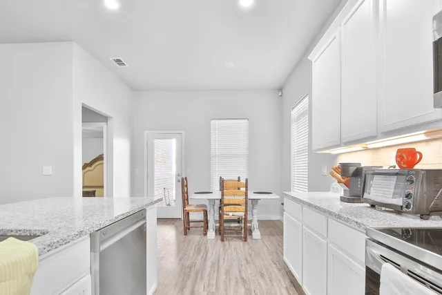 a kitchen with stainless steel appliances granite countertop wooden cabinets and a granite counter tops