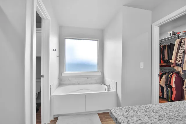 a bathroom with a bathtub and a shower