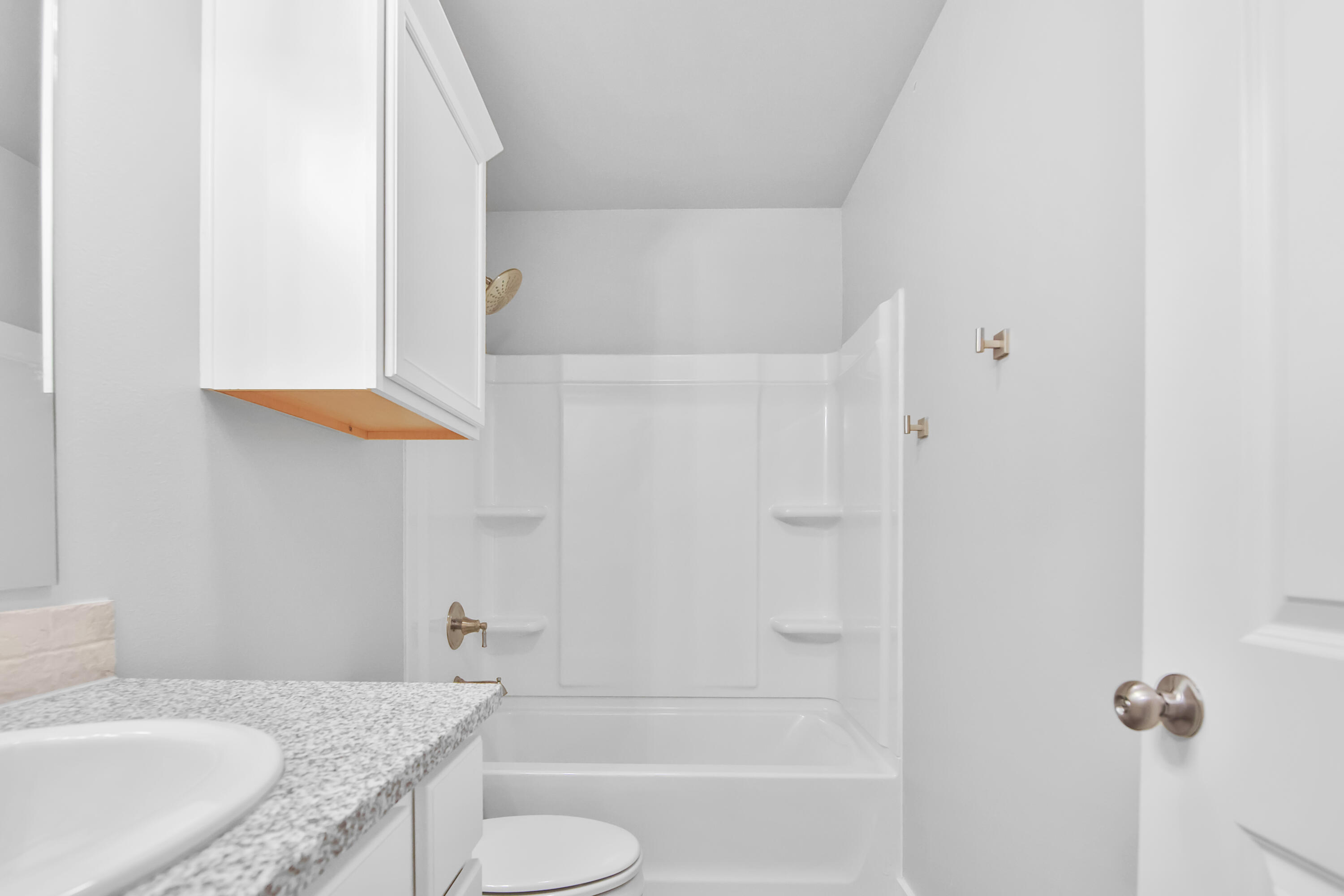1716 133rd Street Lubbock, TX 79423 - Photo 7 of 37 a bathroom with a granite countertop bathtub shower sink vanity and toilet
