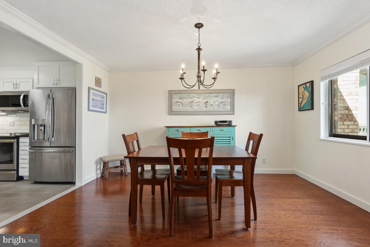 5902 Mt Eagle Drive, Unit 1615 Alexandria, VA 22303 - Photo 17 of 48 a view of a dining room with furniture a chandelier and wooden floor