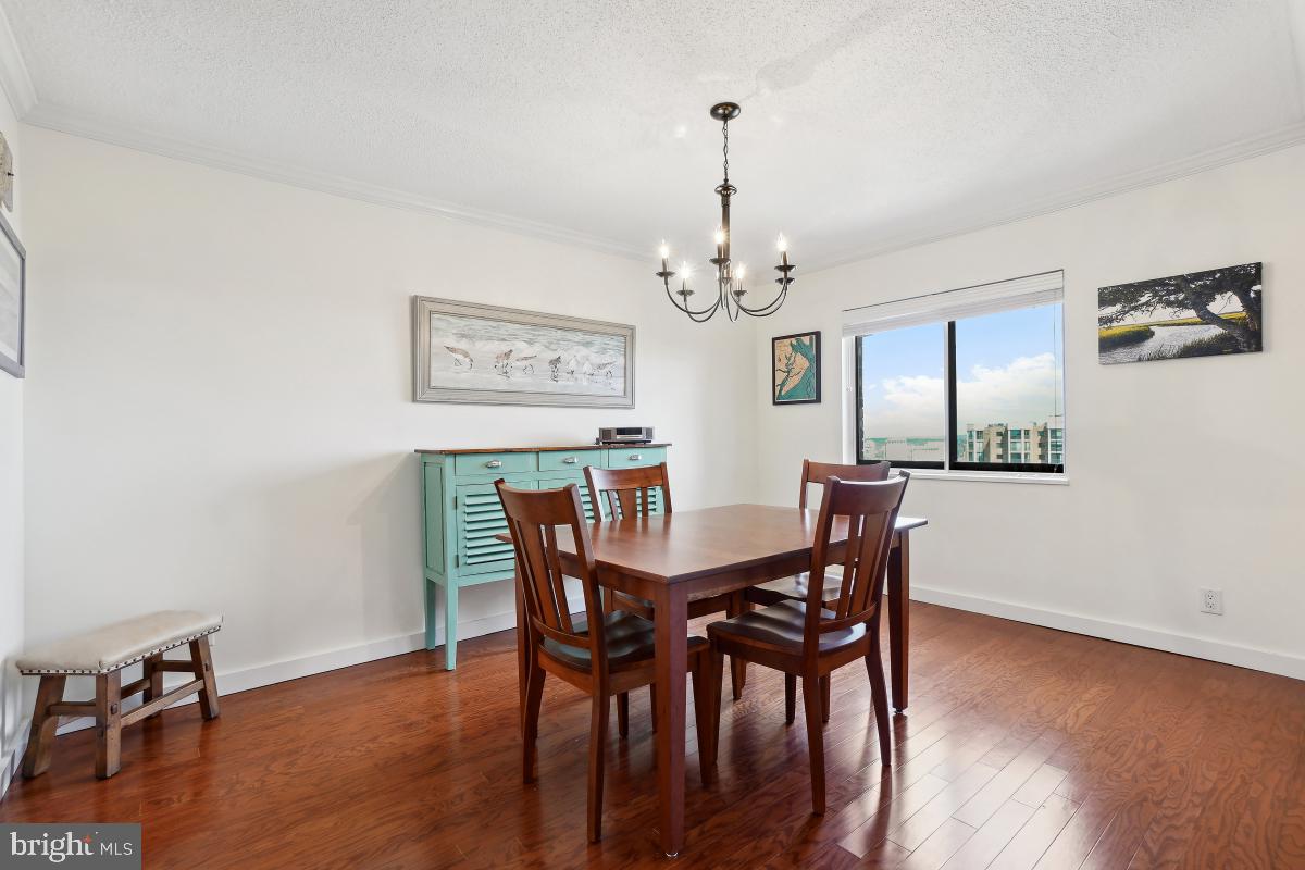 5902 Mt Eagle Drive, Unit 1615 Alexandria, VA 22303 - Photo 18 of 48 a view of a dining room with furniture wooden floor and chandelier