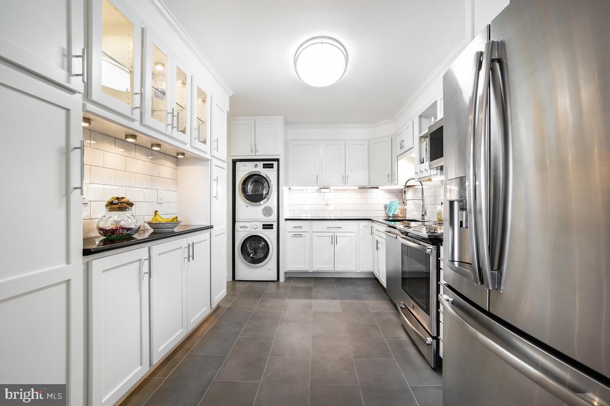 5902 Mt Eagle Drive, Unit 1615 Alexandria, VA 22303 - Photo 22 of 48 a kitchen with white cabinets and white appliances