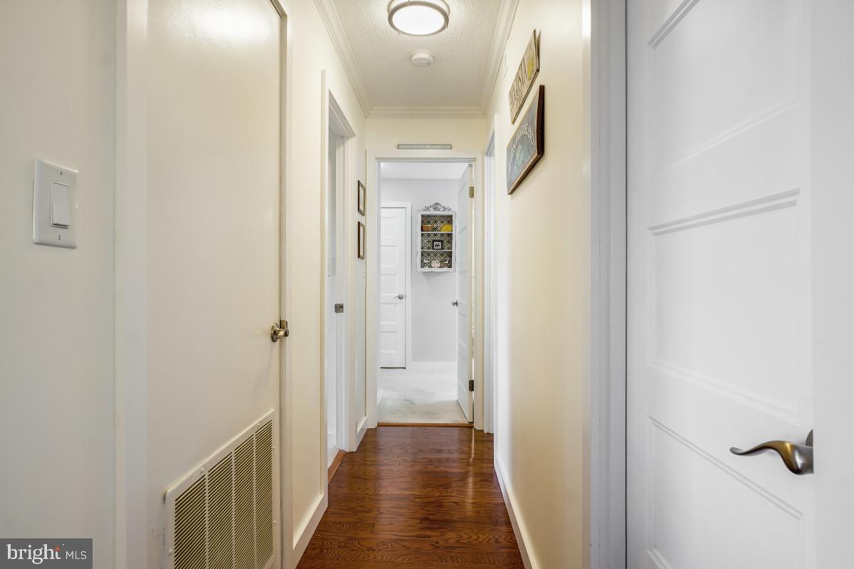 5902 Mt Eagle Drive, Unit 1615 Alexandria, VA 22303 - Photo 28 of 48 a view of a hallway with wooden floor and a bathroom